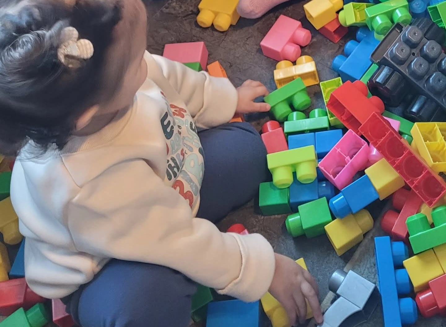 child care image of a toddler with duplo legos