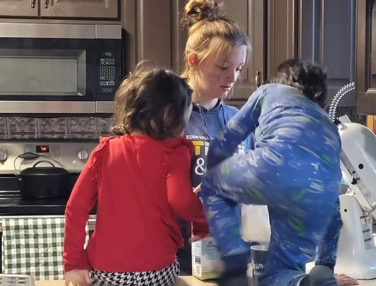 image of a mother and two children in a kitchen