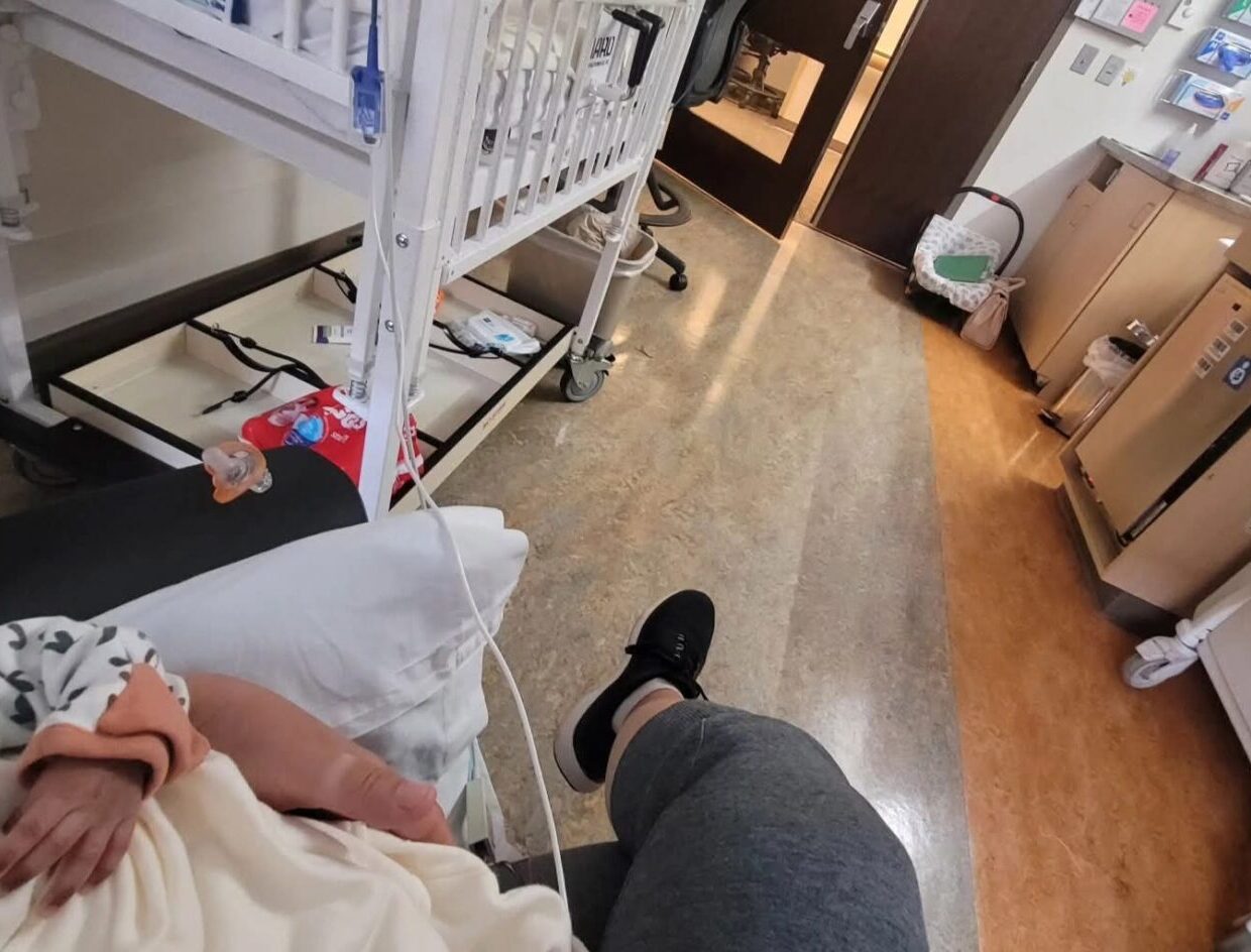 image of a baby being held in a hospital room
